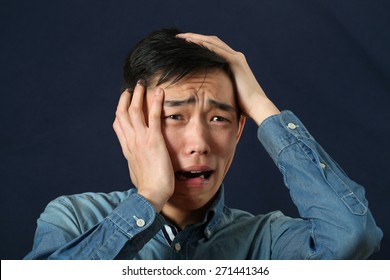 Disappointed Young Asian Man Crying And Looking Sideways