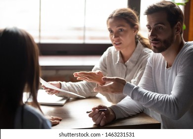 Disappointed Young Couple Meeting With Realtor Or Designer Dispute Complain About Contract Regulations, Dissatisfied Spouse Clients Have Argument With Banker Blame Specialist In Incompetence