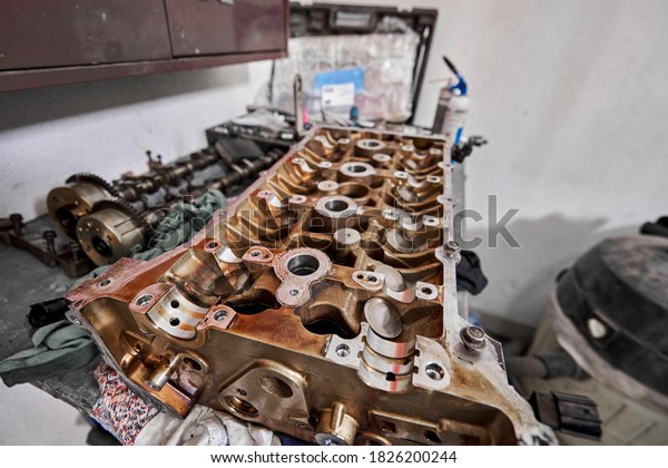 Disassemble engine block vehicle. Motor\
capital repair. Sixteen valve and four cylinder. Car service\
concept. The job of a mechanic. Old and new pistons. Top\
view