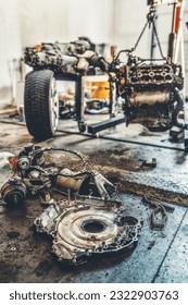 disassemble the engine from the car in the car workshop.