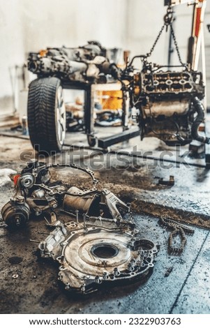 disassemble the engine from the car in the car workshop.