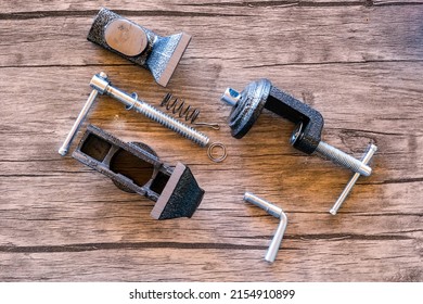 Disassembled Bench Vise Or Clamp On Wooden Table 