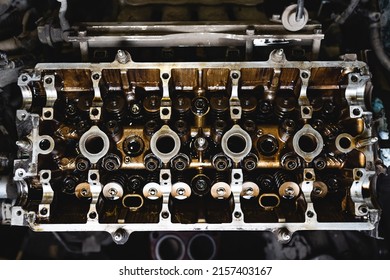 Disassembled Car Engine In Oil. Cylinder Head Of An Automobile Engine. Inside The Car Being Repaired. Sixteen Valves. Car Service. View From Above