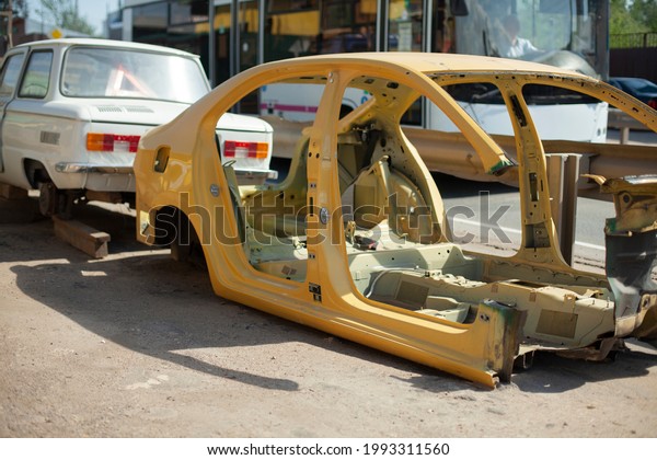 Disassembled car frame on\
the street. Car after an accident. Unsuitable vehicle for use.\
Damaged machine\
frame.