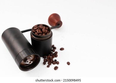 A disassembled coffee grinder with coffee beans inside. on an isolated white background.