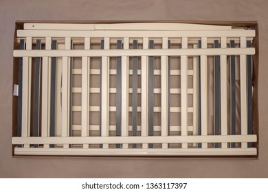 Disassembled Crib In Cardboard Box. Crib Assembling.