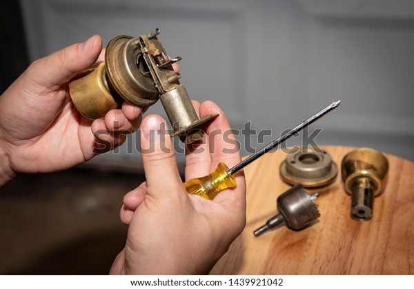 Disassembled Doorknob Undergoing Repair Mans Hands Stock Photo
