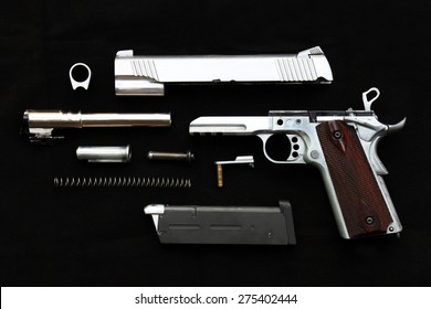 Disassembled Handgun On Black Background, Seperate Parts Handgun. Pistol Part.