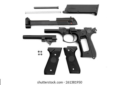 Disassembled Handgun On White Background. Seperate Parts Handgun. Pistol Part.