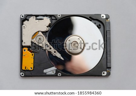 Disassembled hard drive from the computer, hdd with mirror effect Opened hard drive from the computer hdd disk drive