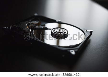 Disassembled hard drive from the computer, hdd with mirror effect Opened hard drive from the computer hdd with mirror effects Part of computer pc, laptop Closeup HDD