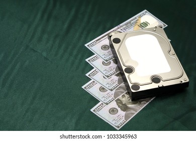 disassembled hard drive on money background. Concept of information safety