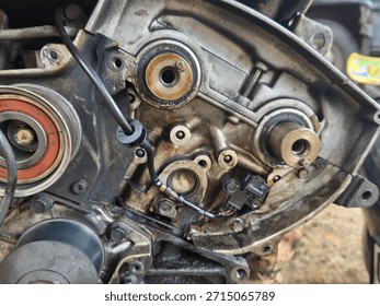 Disassembled Internal Engine Components: A Detailed Close-up of Metal Gears, Seals, and Housing with Oil Residue, Highlighting Complex Automotive Engineering and Mechanical Repair Process