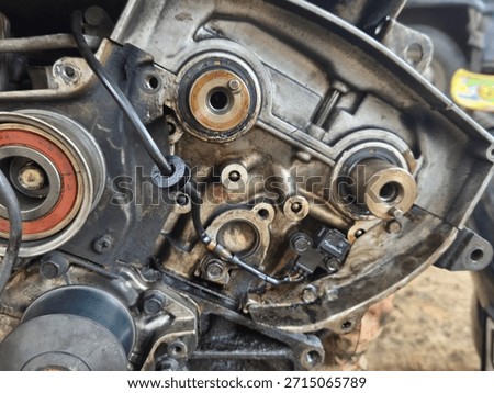 Disassembled Internal Engine Components: A Detailed Close-up of Metal Gears, Seals, and Housing with Oil Residue, Highlighting Complex Automotive Engineering and Mechanical Repair Process