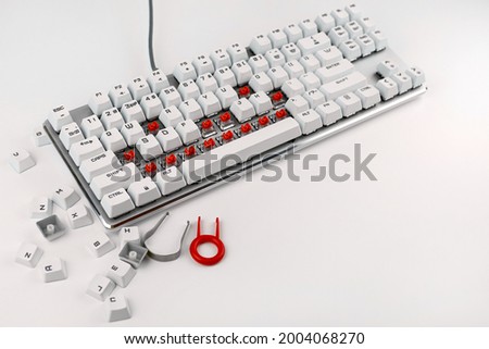 Disassembled keyboard on a white background. Disassembly and cleaning of the computer keyboard. Cleaning of computer equipment. Mechanical keyboard switches.