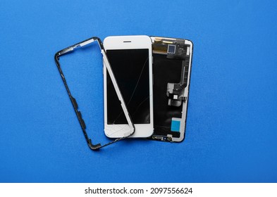 Disassembled mobile phone blue background