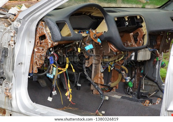 disassembled\
panel of an old car with a lot of\
wires