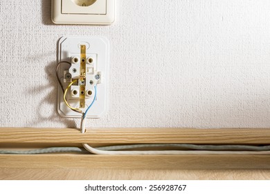 Disassembled power socket on the wall.
