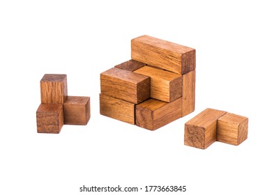 Disassembled puzzle cube 7. Wooden puzzle consisting of 7 parts isolated on a white background. Copy space.