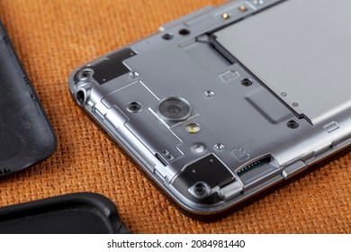 Disassembled Smartphone With Back Plate Off Closeup, Mobile Phone Taken Apart On The Table, Object Up Close, Detail. Electronics, Electronic Device Service And Repair Simple Abstract Concept, Nobody