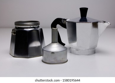 A Disassembled Vintage Classic Aluminium Stovetop Espresso Coffee Maker On A Simple White Background