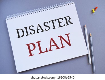Disaster Plan text written in Notebook. Concept meaning Respond to Emergency Preparedness Survival and First Aid Kit