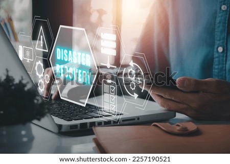 Disaster Recovery concept, Person hand using laptop computer with Disaster Recovery icon on virtual screen.