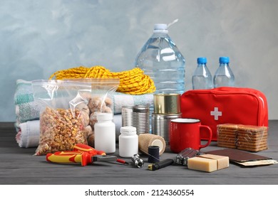 Disaster Supply Kit For Earthquake On Black Wooden Table