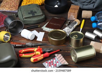 Disaster Supply Kit For Earthquake On Wooden Table