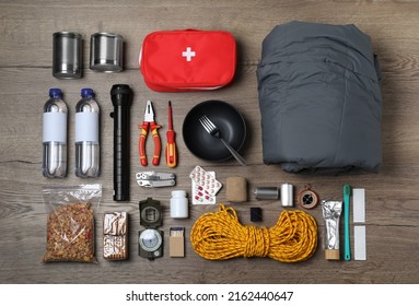 Disaster Supply Kit For Earthquake On Wooden Table, Flat Lay