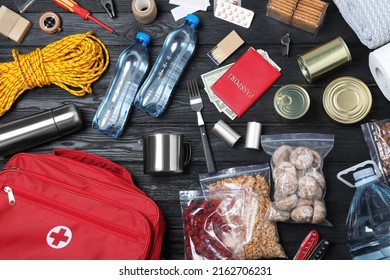 Disaster Supply Kit For Earthquake On Black Wooden Table, Flat Lay