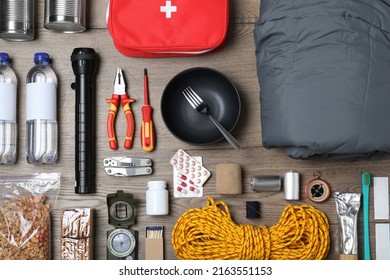 Disaster Supply Kit For Earthquake On Wooden Table, Flat Lay