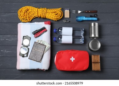 Disaster Supply Kit For Earthquake On Black Wooden Table, Flat Lay