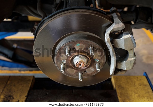 disc brake of a car to be fixed at garage, shallow\
depth of field