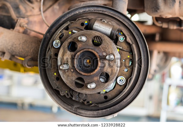 Disc brake on car, in process of car brake\
repairing in car repair\
shop.