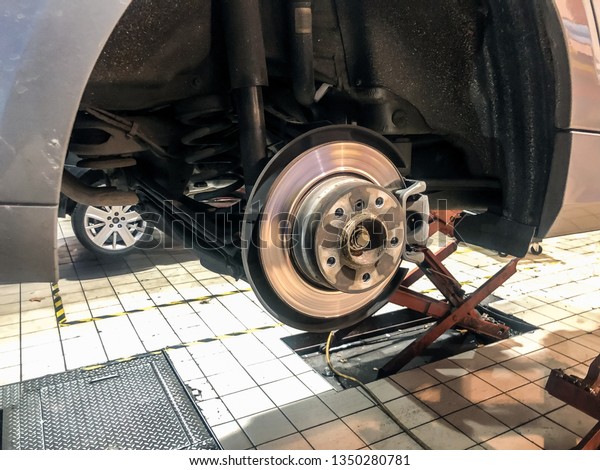 Disc\
brake of a suspended car in inspection in a\
workshop