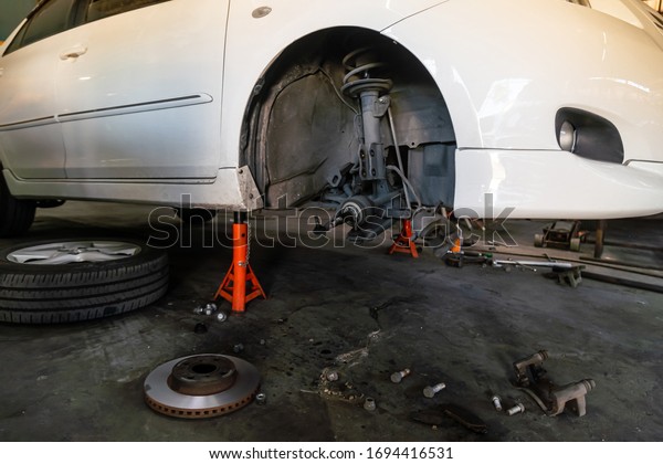 Disc brake System in the vehicle for\
repair,  Car Brake Repairing on White\
Background.