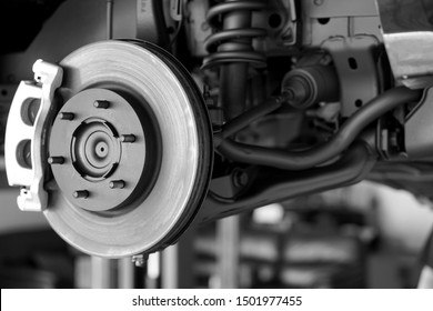 Disc brake of the vehicle for repair, in process of new tire replacement. Car brake repairing in garage.Suspension of car for maintenance brakes and shock absorber systems.Close up.         - Shutterstock ID 1501977455