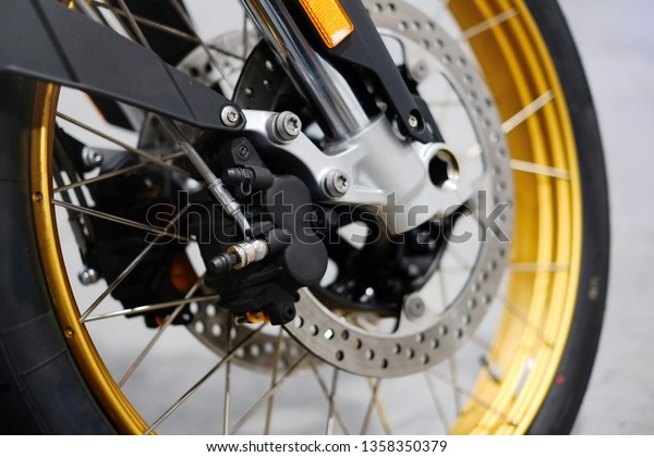 Disc brake with wheel hub on motorbike.\
Close up of front disc brake on motorcycle. Motorcycle car care and\
maintenance concepts. - Selective\
focus.