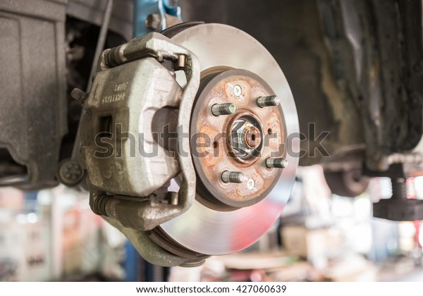 Disc brakes. assembly on a modern automobile -\
Brake work in progress.