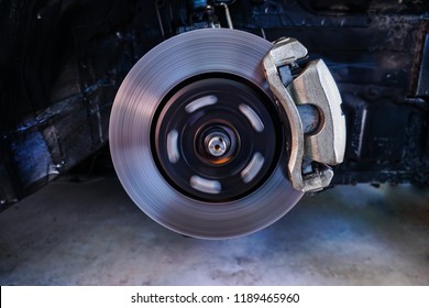 Disc brakes, stopping the break ,Car Suspension and car bearing parts concept - New front wheels car bearing for disc brake type bearing on replacement service in garage and copyspace.2
