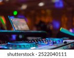 Disc Jockey, aka a DJ, at a party. Visuals of the DJ Table with party lights