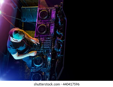 Disc jockey mixing electronic music in club. Shot from aerial perspective. Copyspace for text