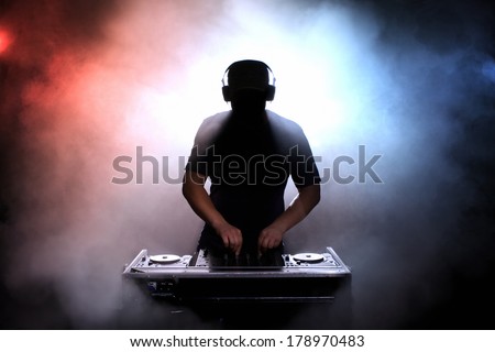 Disc jokey, DJ, silhouette over foggy illuminated background Сток-фото © 