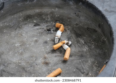 Discarded cigarette buds in ask tray 