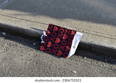 Discarded Heart Gift Bag in New York City Gutter - Shutterstock ID 2306753521