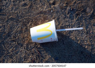 Discarded Mcdonalds Paper Cup, Cola And Fast Food Packaging On The Ground. People Left Behind Trash. Fast Food Rubbish. Russia, Moscow, 04.10.2021.