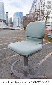 Discarded Old Office Chair In An Empty Urban Parking Lot In Long Island City Queens New York