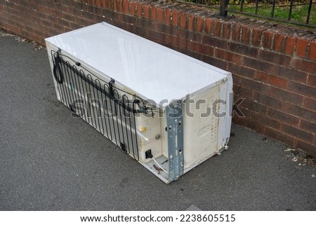 discarded refrigerator left on pathway. Kitchen white goods dumped in street.  Old fridge freezer illegally tipped 