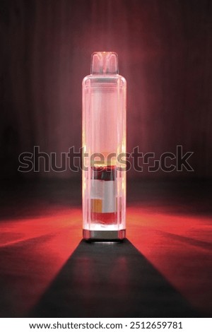 Discarded single use electronic cigarette vape stripped of its metal casing and backlit to show internal components of the device. A battery at the base, and wicking foam at the top